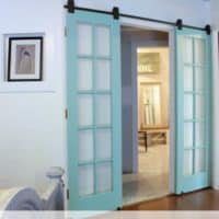 Reclaimed french doors on a barn door track